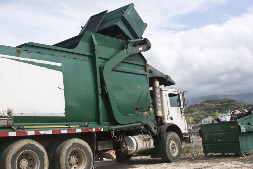 Front view of commercial waste containers in Richmond near a recycling area